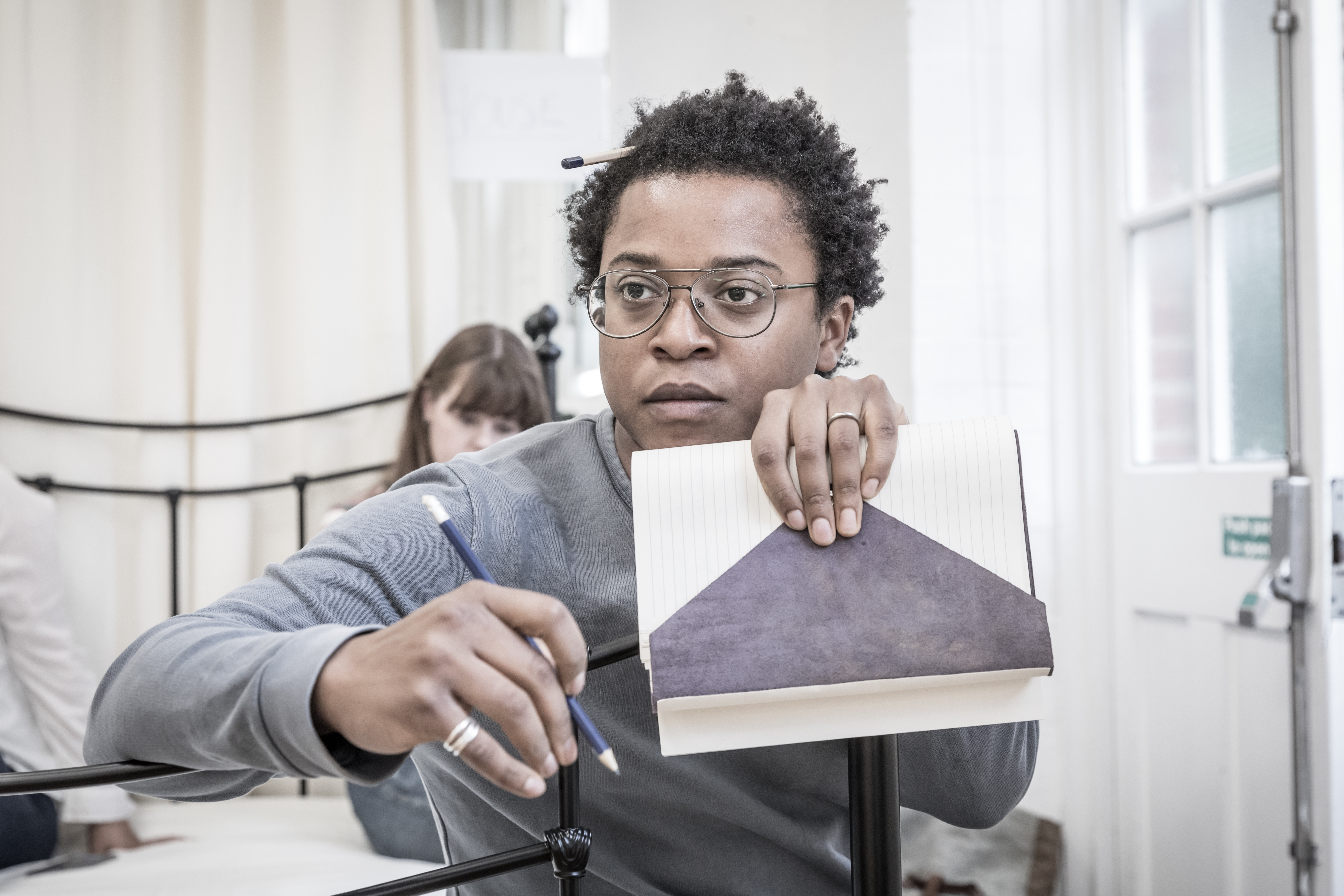 Young man holding up a notepad